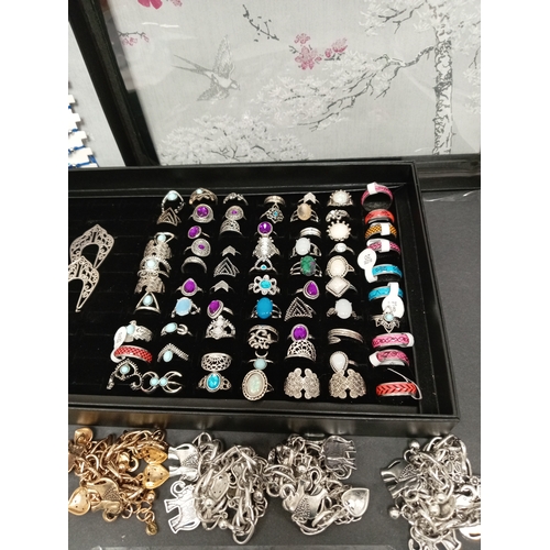 723 - Job lot of costume rings in ring box,white metal earrings, yellow metal and white metal charm bracel... 