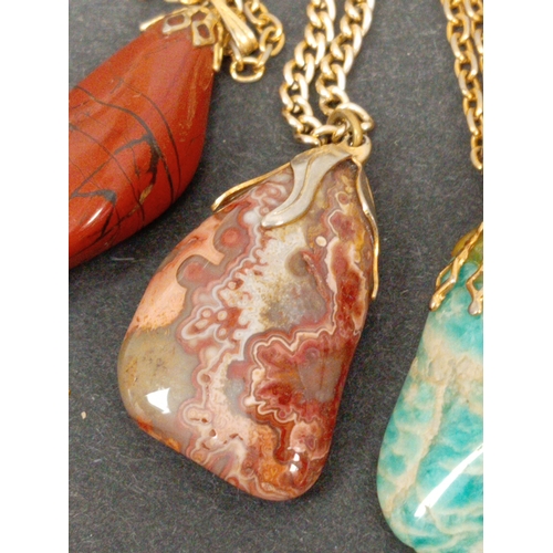 744 - Four vintage Agate stone pendants on chains.