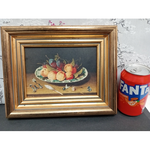 504 - Still life on board nectarines and plums on a blue and white plate in a gold frame. H 22cm x W 26cm.