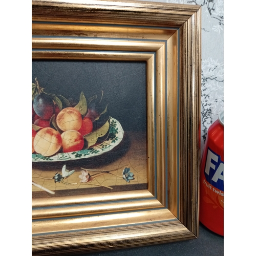 504 - Still life on board nectarines and plums on a blue and white plate in a gold frame. H 22cm x W 26cm.