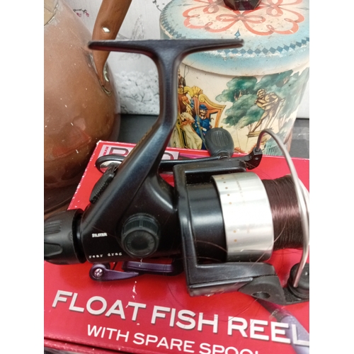 467 - 1952 RAF hat, vintage tin, Silstar rear drag fishing reel and a copper and brass vase/water vessel.