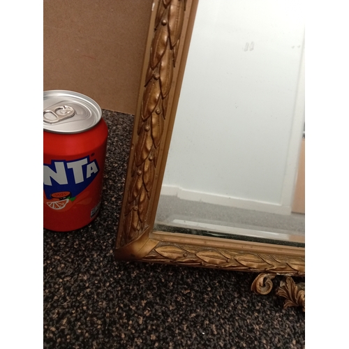 478 - Ornate gold framed bevelled mirror. H 79cm x W 39cm.