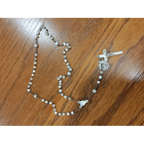 652 - A carved mother of faux pearl rosary necklace with a faux mother of pearl crucifix and a silver jesu... 