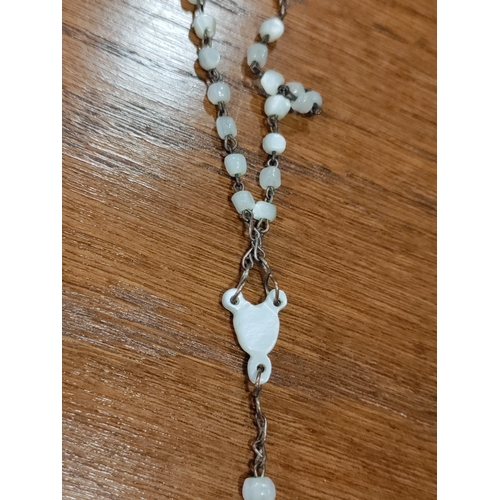 652 - A carved mother of faux pearl rosary necklace with a faux mother of pearl crucifix and a silver jesu... 