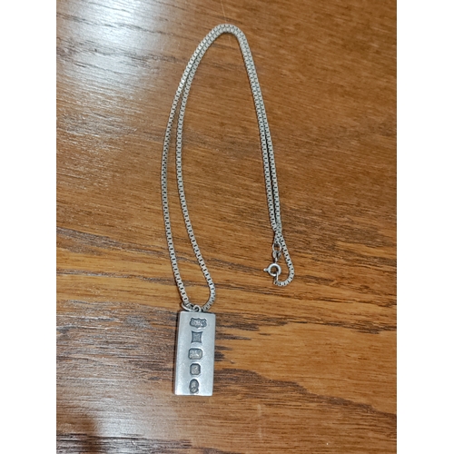 654 - A hallmarked silver ingot pendant on a 925 silver link chain. Weight