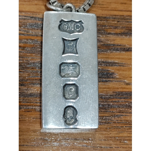 654 - A hallmarked silver ingot pendant on a 925 silver link chain. Weight