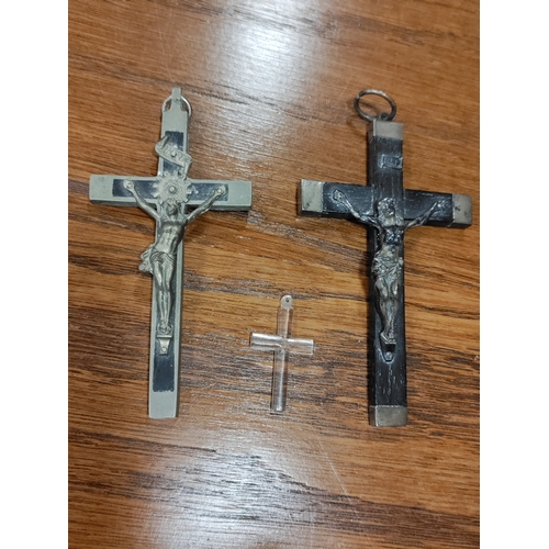 656 - A trio of wood/metal crucifixes. One is believed to be silver.