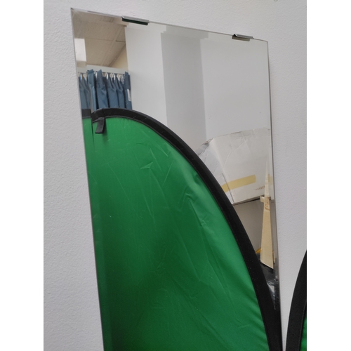 487 - A tall thin bevelled edge mirror with wall mounts. H 165cm x W 26cm