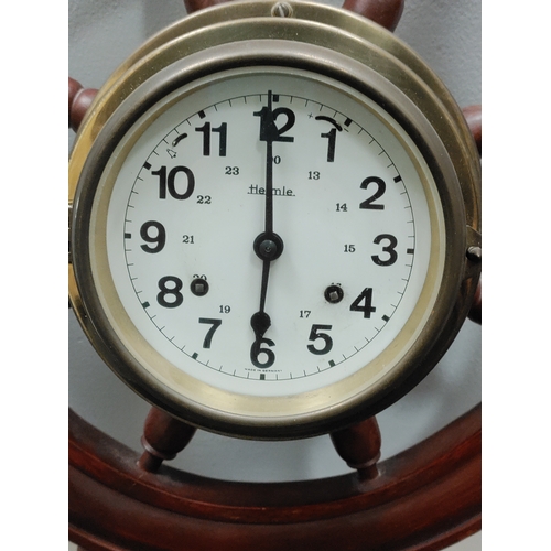 495 - German Hermle ships wheel clock. Has an alarm and winder. H 57cm x W 57cm