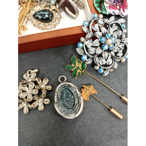 683 - Box of costume jewellery to include pendants, brooches, necklace, tie pins,etc.