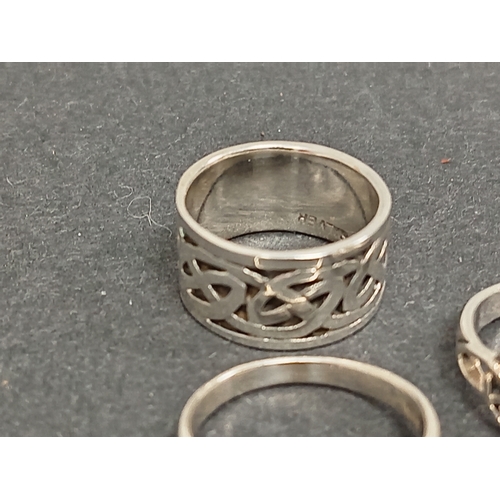 693 - Three celtic 925 silver rings, one with red stone size M, one green stone size L and a celtic band r... 