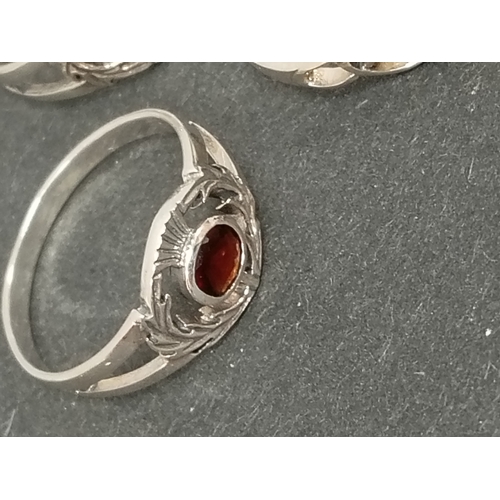 694 - Two 925 silver thistle rings one with red stone size T and a lilac stone ring size P and one 925 sil... 