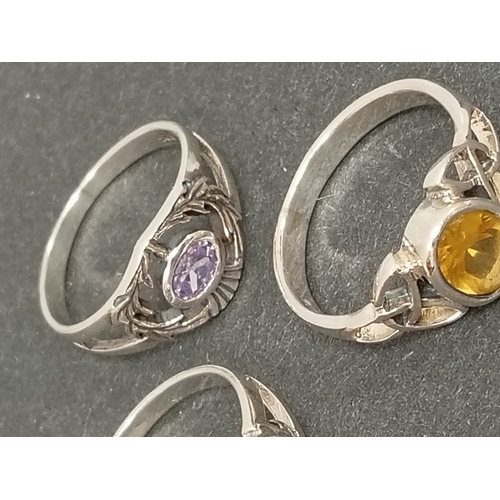 694 - Two 925 silver thistle rings one with red stone size T and a lilac stone ring size P and one 925 sil... 