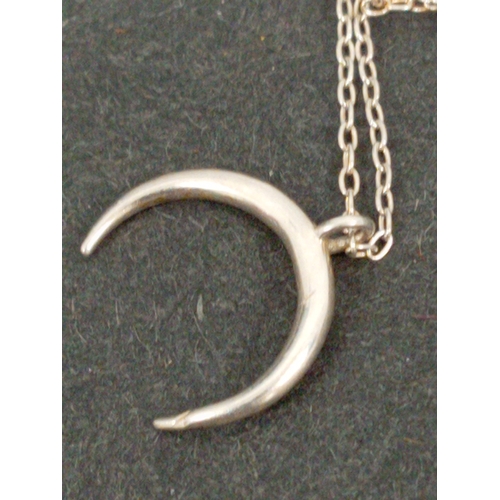 695 - Three 925 silver pendants on chains includes Modernist, twirl twist and crescent moon pendants.