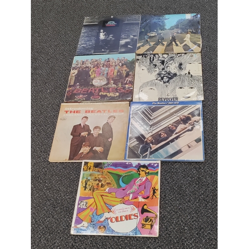 610 - A collection of 7 Beatles and John Lennon vinyl record albums. In varied condition.