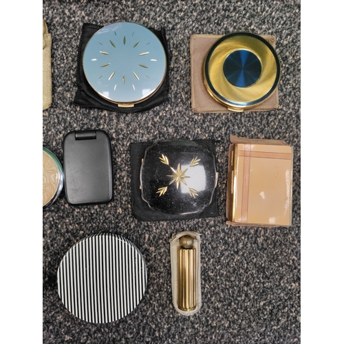 561 - A job lot of 12 compacts, some mirrors, a perfume bottle and a brush. Brands include Stratton, Etien... 