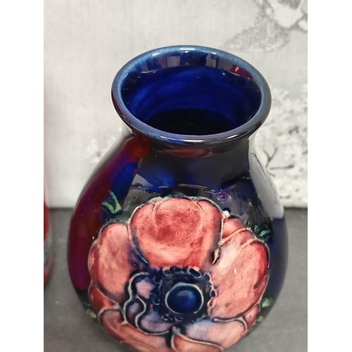 566 - Early 20th century Moorcroft pink anemone on cobalt blue ground vase. H 10cm x W 7cm.