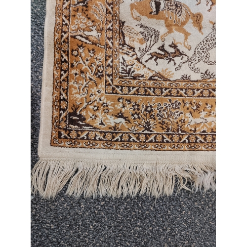 580 - A vintage brown and cream silk rug with tassels picturing men with swords on horse back.