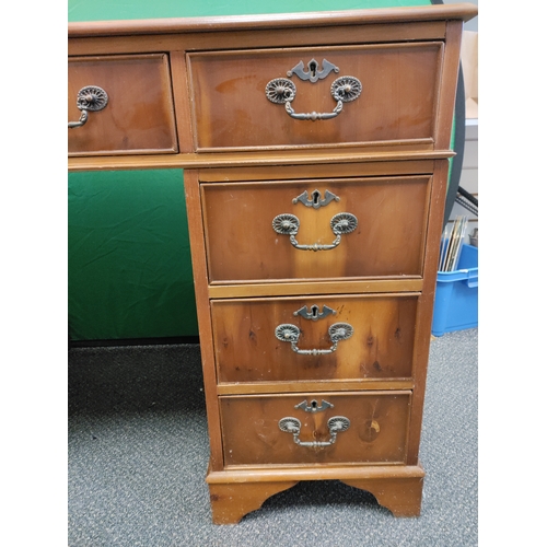 598 - A large red leather topped wooden desk with 9 drawers and original key, desk comes apart into 3 sect... 