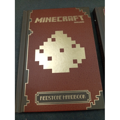 625 - Minecraft Mojang Red stone handbook and a Minecraft Mojang combat handbook.