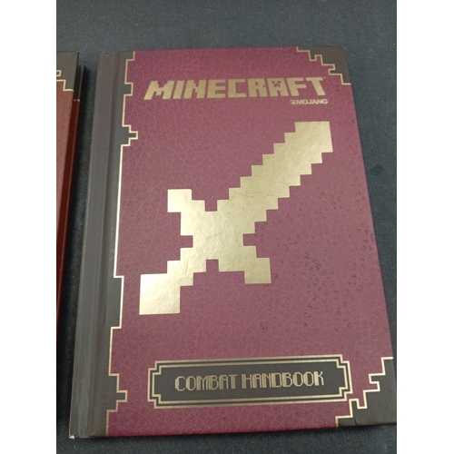 625 - Minecraft Mojang Red stone handbook and a Minecraft Mojang combat handbook.