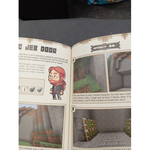 625 - Minecraft Mojang Red stone handbook and a Minecraft Mojang combat handbook.