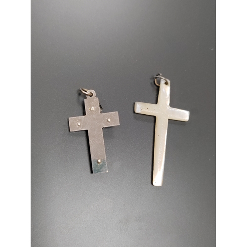 705 - Two vintage crucifix cross pendants. One is hand carved mother of pearl.