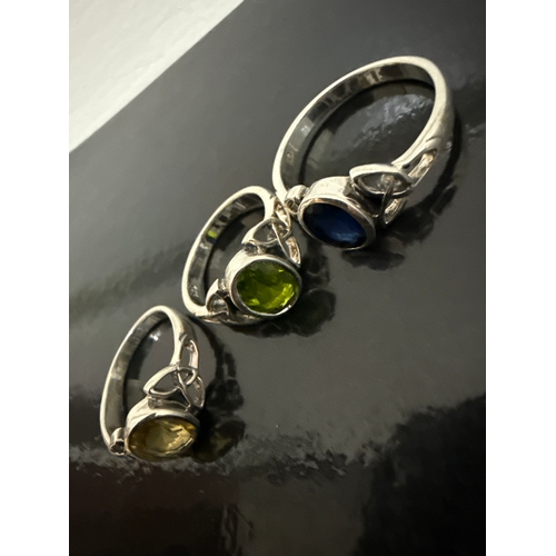 718 - 3 ornate 925 silver rings. One with a blue stone, one a green stone and one a yellow stone