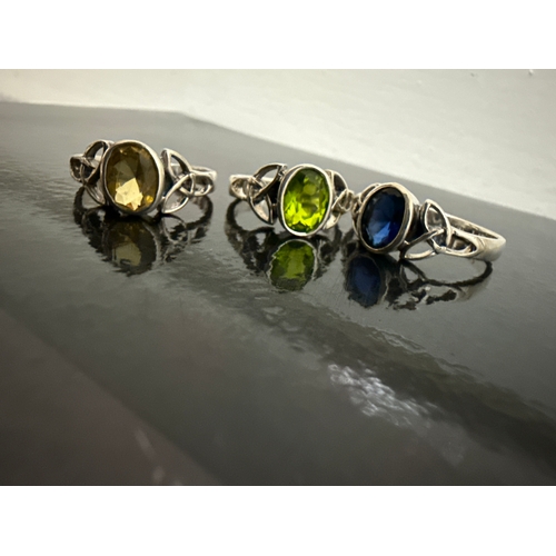 718 - 3 ornate 925 silver rings. One with a blue stone, one a green stone and one a yellow stone