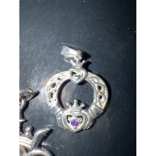 720 - 3 925 silver pendants. One Scottish thistle  style, one ornate with an amethyst colour stone and the... 