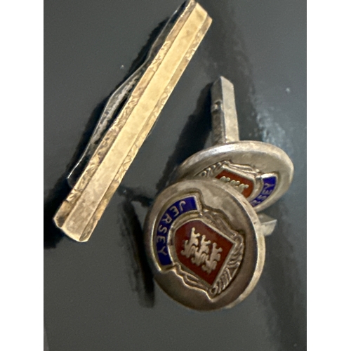 722 - Silver and enamel Jersey cuff links and a gold plated silver tie pin.