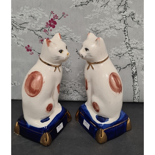 438 - Pair of white & ginger ceramic Cats with blue & gilt bases. Each measures H29cm x W10cm