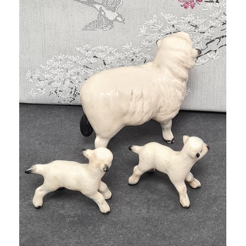 427 - Family of ceramic sheep, Ewe is marked Beswick and 2 lambs marked England.