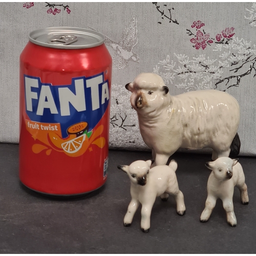 427 - Family of ceramic sheep, Ewe is marked Beswick and 2 lambs marked England.