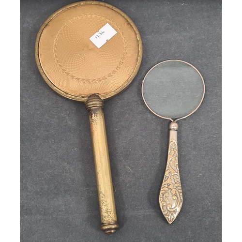 409 - Vintage Ladies handheld vanity mirror and a magnifying glass with ornate designed handle.