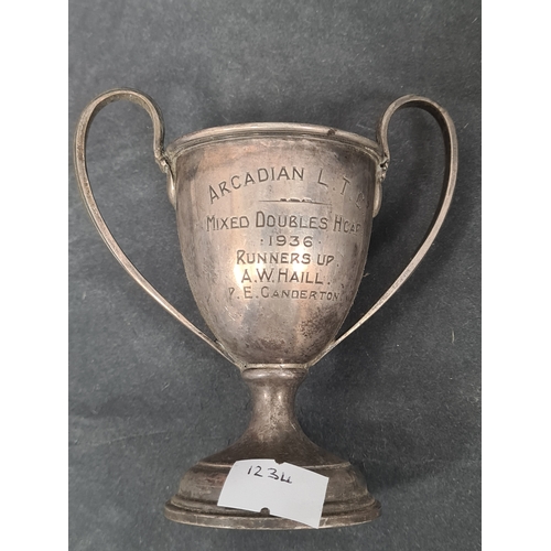 725 - One hallmarked silver small trophy cup and one small trophy cup stamped EPNS to include: Arcadian LT... 