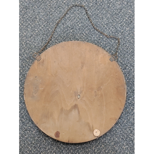 507 - A round antique Edwardian bevelled edge mirror. Diameter 34cm.