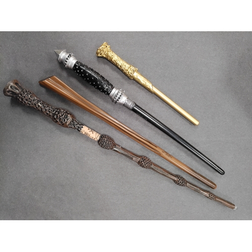 528 - A collection of 4 Harry Potter wands; The gold one is also a pen.