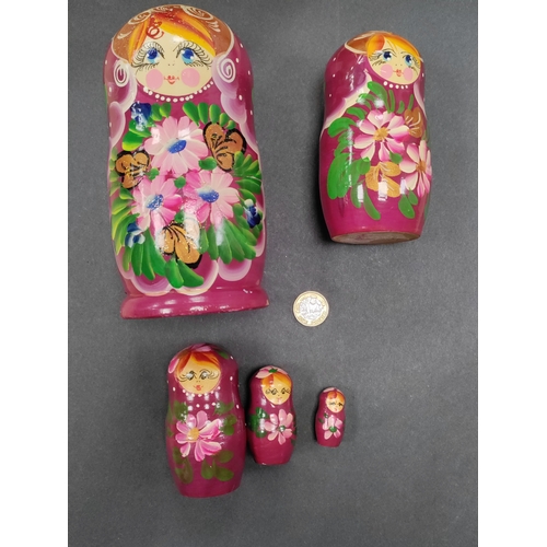 532 - A nest of 5 Russian purple wooden nesting dolls with floral patterns