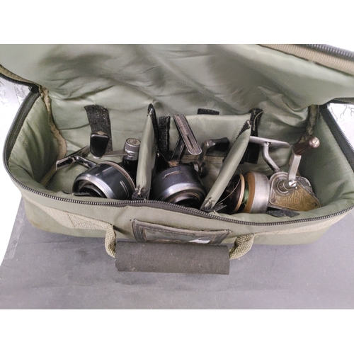 543 - A space fishing tackle reel bag with three reels. One J.W YOUNG & Sons The Ambidex No.2 and 2 ABU 50... 