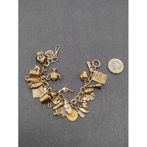 853 - A stunning fully hallmarked 9ct charm bracelet with 25 charms. Every charm and link on the bracelet ... 