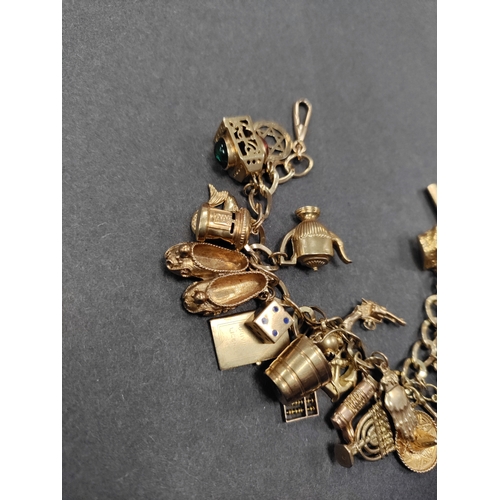 853 - A stunning fully hallmarked 9ct charm bracelet with 25 charms. Every charm and link on the bracelet ... 