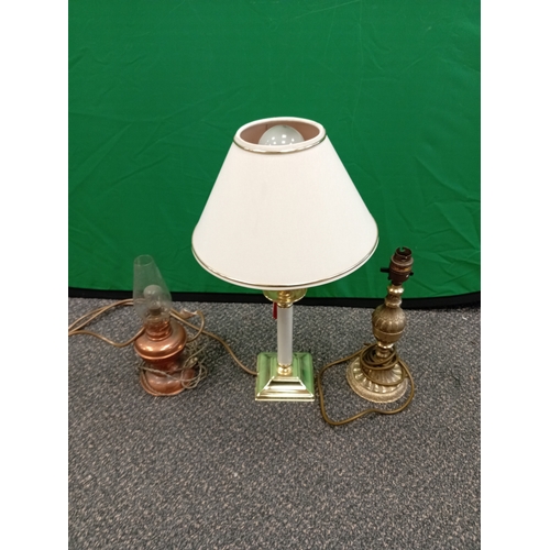 546 - A trio of lamps. One modern, one cast brass and one small copper oil lamp style.