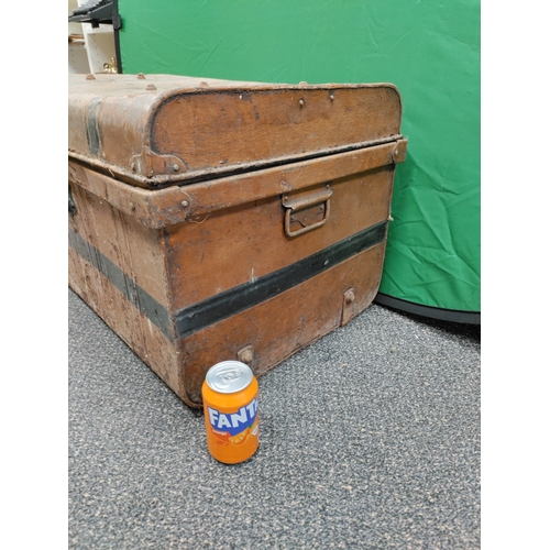 547 - A large brown and black antique metal trunk; Latch stamped E.Bates Wolverhampton lever.