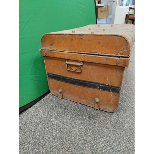 547 - A large brown and black antique metal trunk; Latch stamped E.Bates Wolverhampton lever.