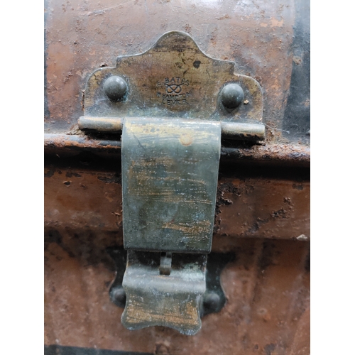 547 - A large brown and black antique metal trunk; Latch stamped E.Bates Wolverhampton lever.