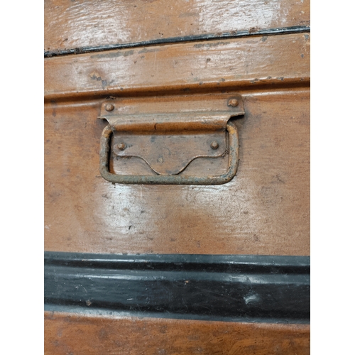 547 - A large brown and black antique metal trunk; Latch stamped E.Bates Wolverhampton lever.