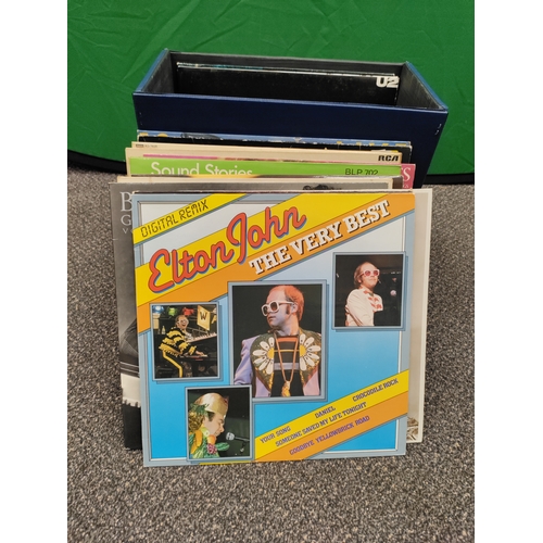 596 - 24 vinyl records in carry case with original key. Collection consists of Elton John, Genesis, Elvis,... 