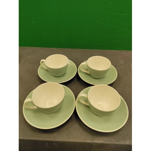 610 - Set of four light green 1960s Poole Pottery tea cups and saucers.