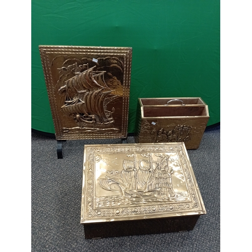 672 - A vintage embossed brass fire screen, Art deco brass magazine rack and an embossed brass coal scuttl... 